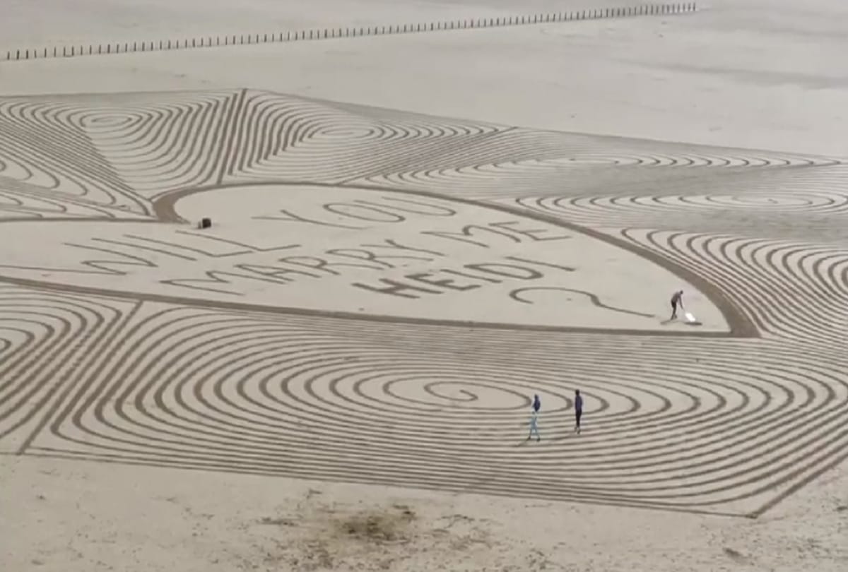 Unique marriage proposal Man propose his girlfriend at a beach by creating sand art