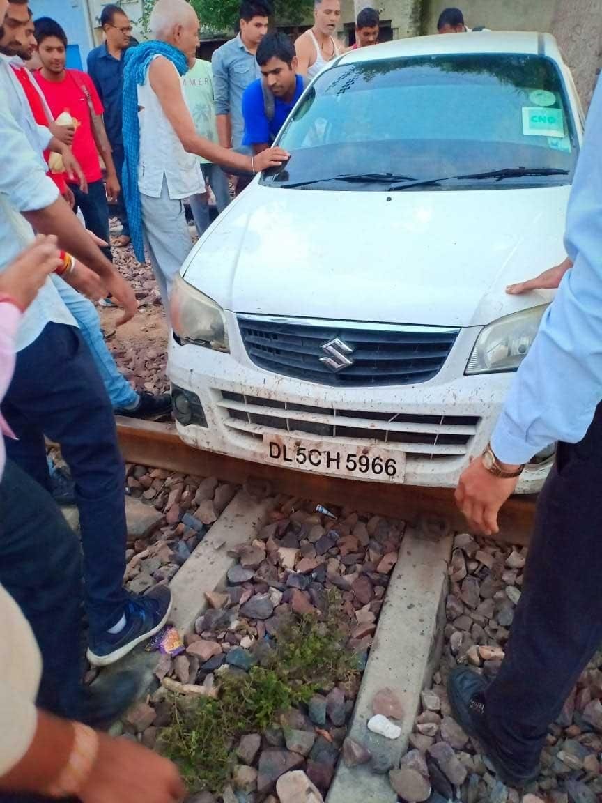 car stuck between railway line