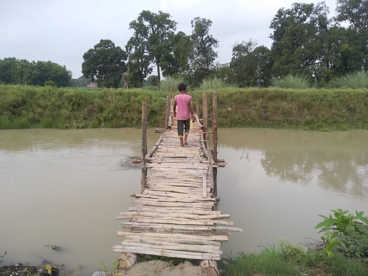The villagers built a wooden bridge by collecting donations