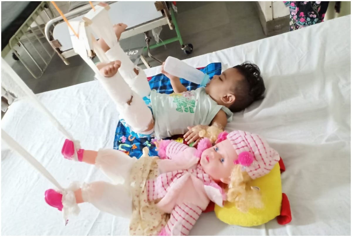 baby girl cooperating in treatment with the help of her doll