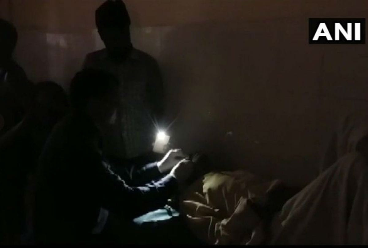 patient stitches by staff in flashlight of mobile phone at district hospital