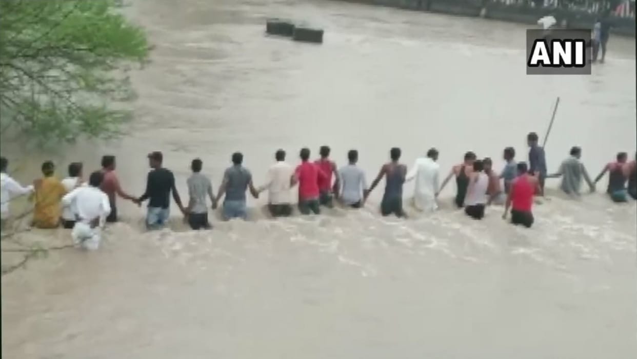 villagers in Indore formed human chain to rescue two men washed away in overflowing stream