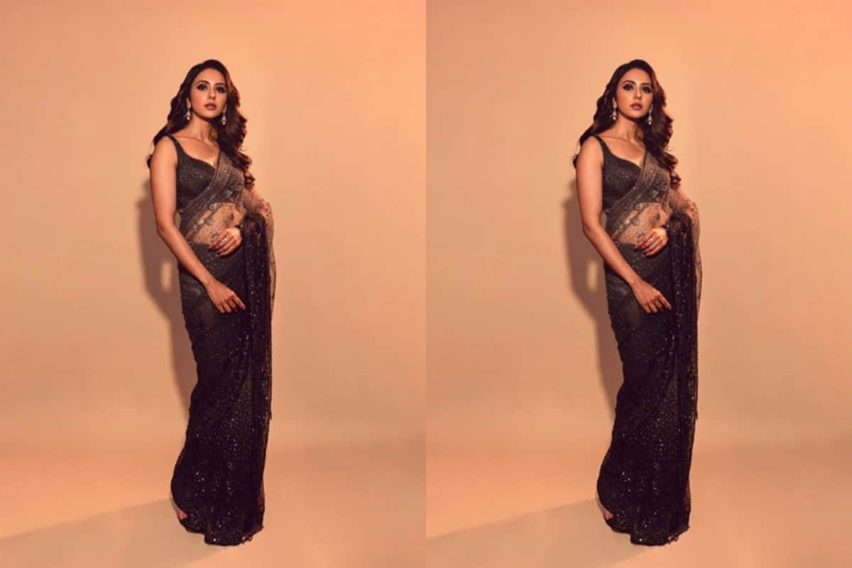 rakul preet looks stunning in traditional black net saree design by tarun tahiliani