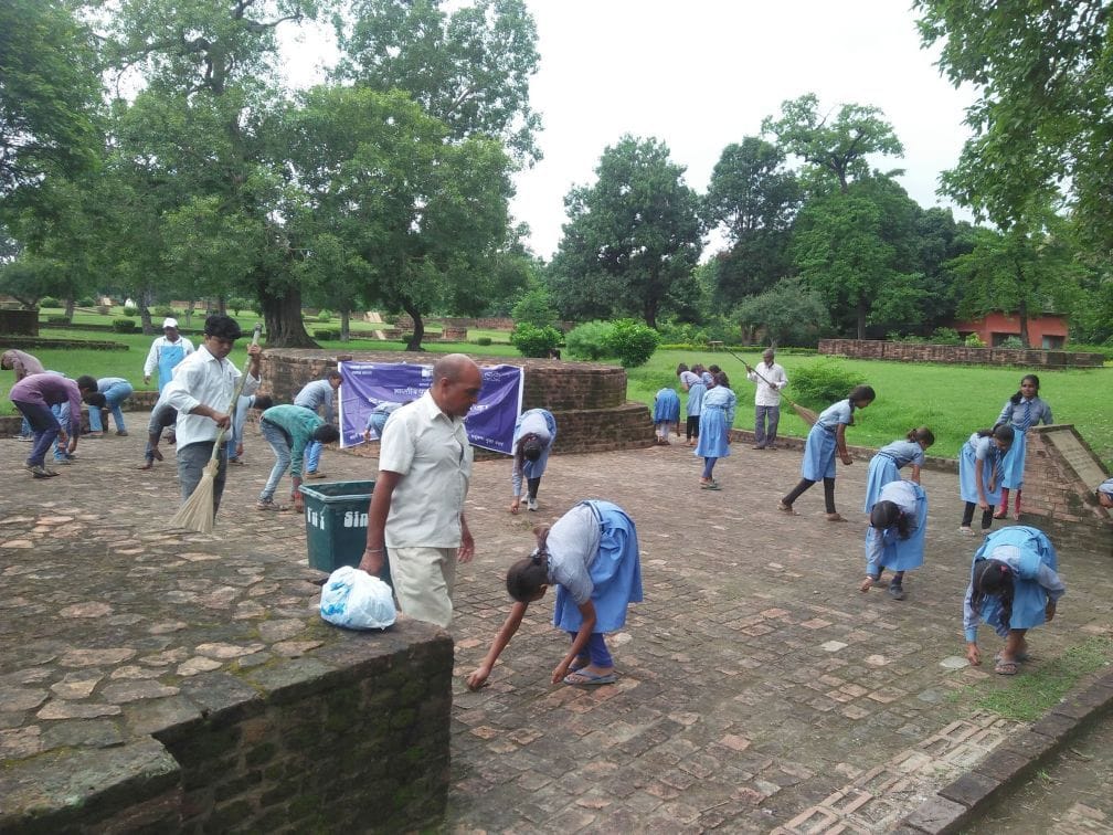 Officials and students cleaning