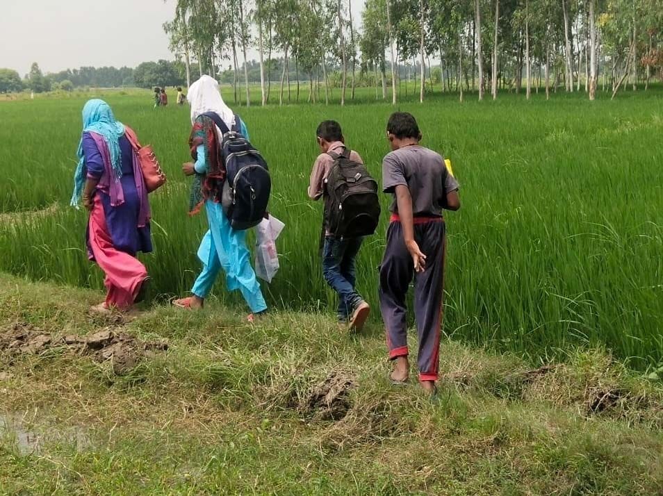 Children reach school through the ridge of farmland for six years