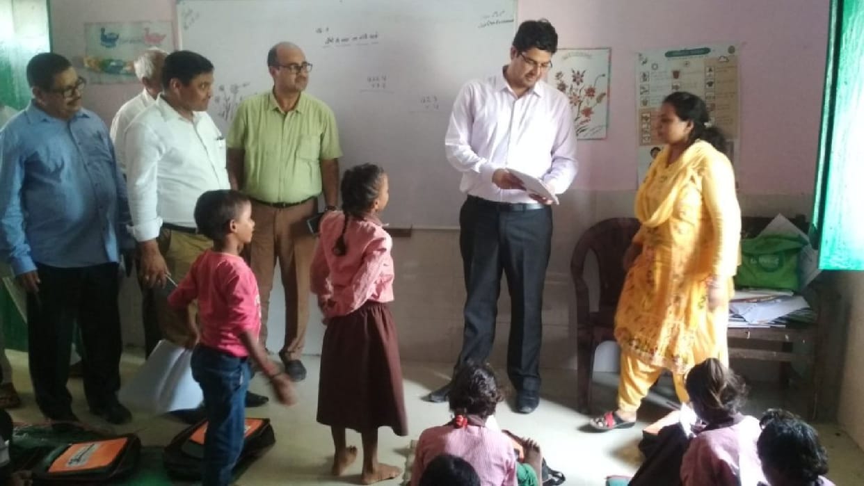 DM examines copies, asks math questions to children