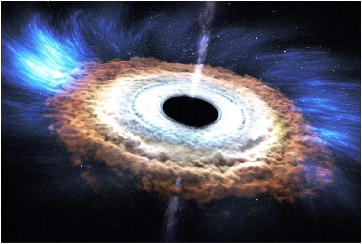 black hole eating one sun every day producing light glow seen Earth 12 billion light years away