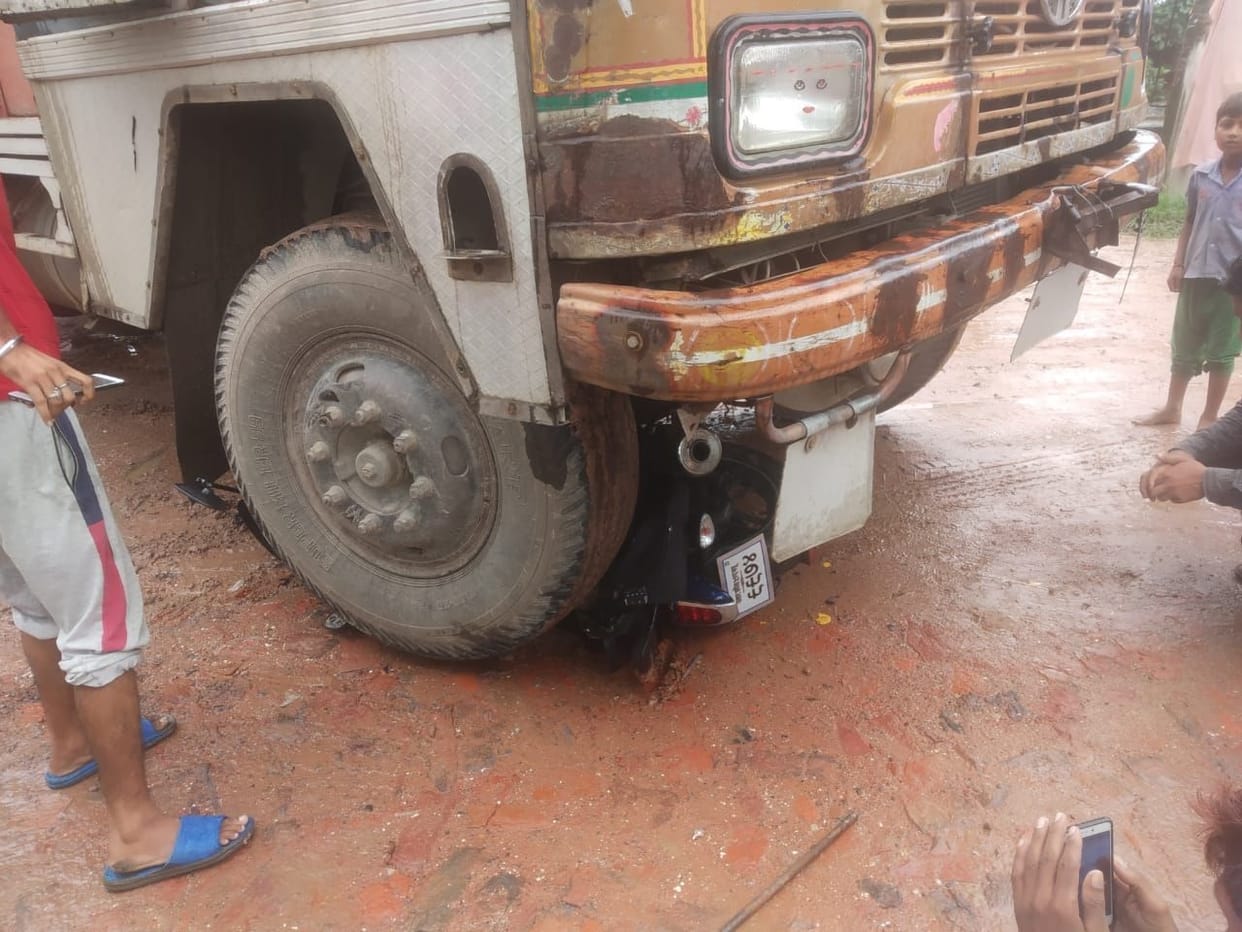 A young man entered under the truck along with the bike