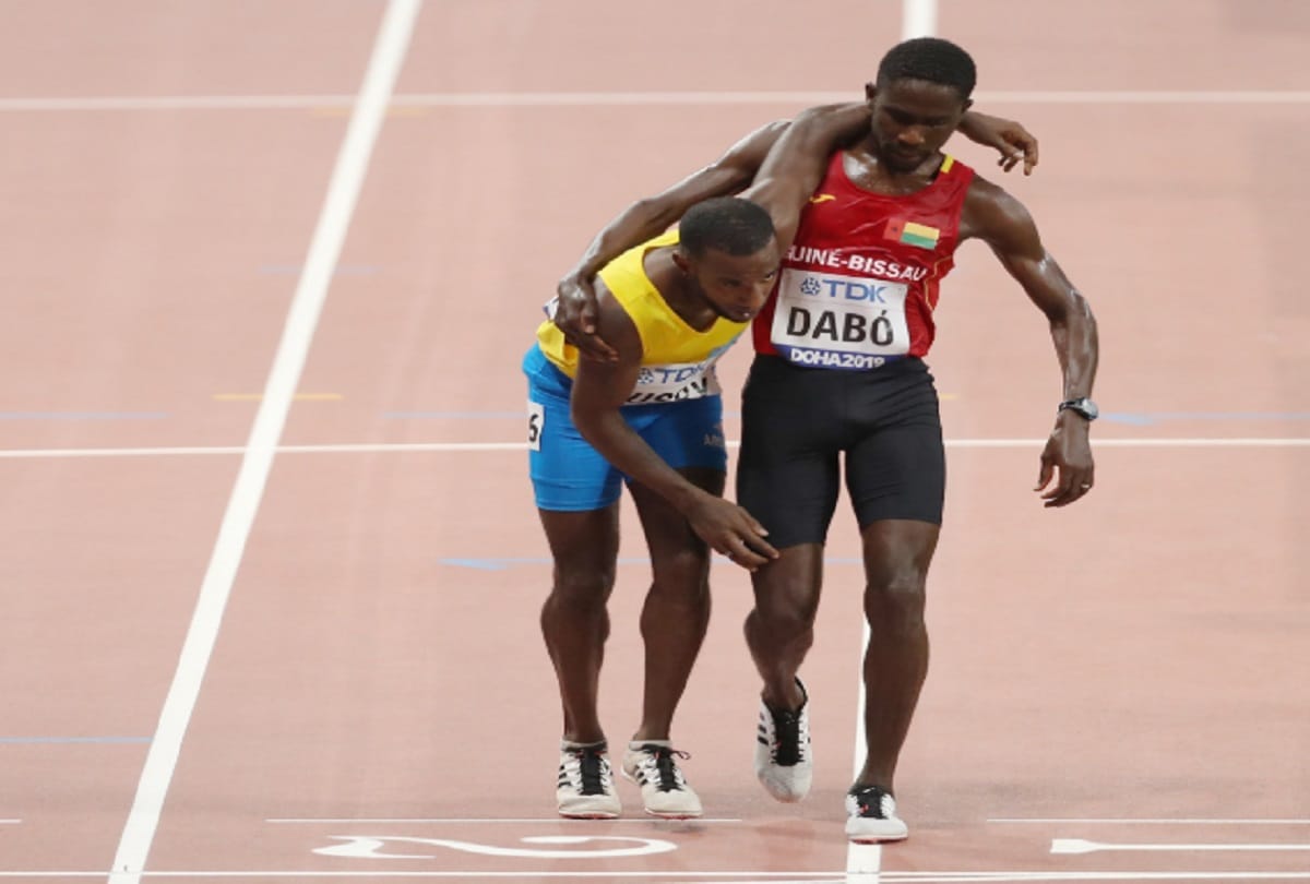 world championship Braima Dabo of Guinea Bissau wins heart helped injured Busby to complete race