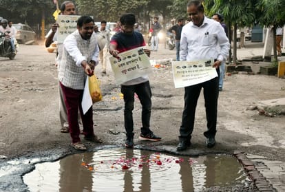 People honour pathole of roads and give award.
