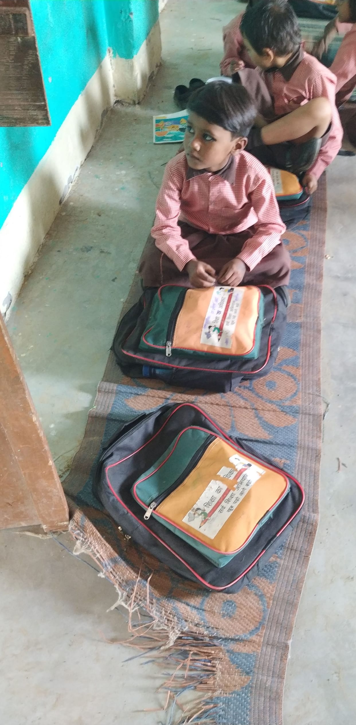 Children forced to sit on sacking