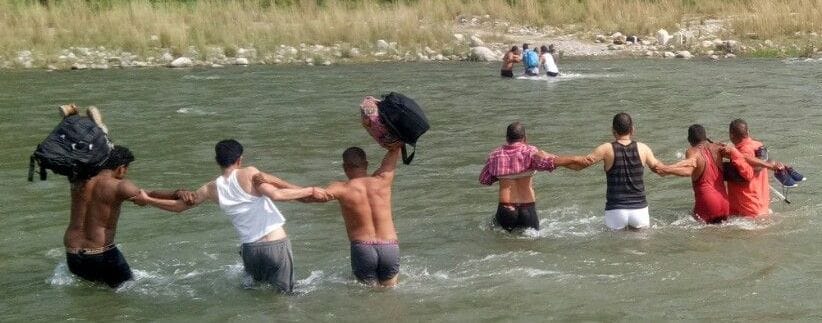 Officers descended into the river by placing clothes on their shoulders and polling bags on the head