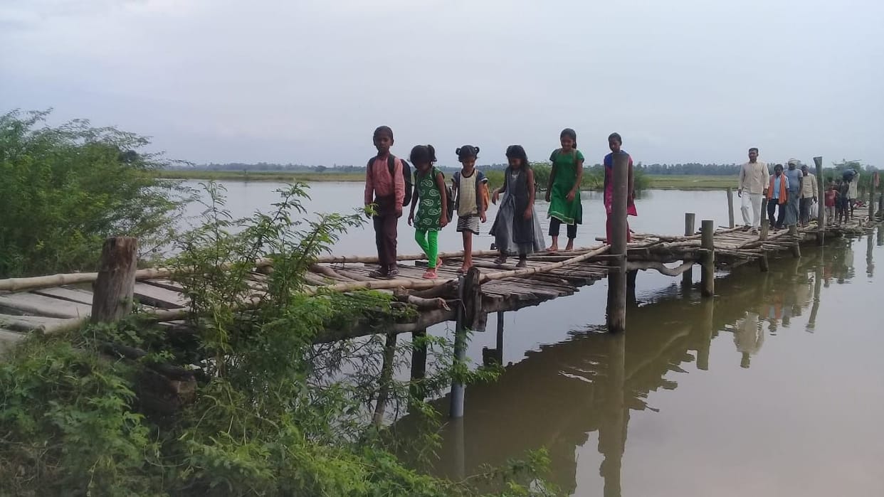 People move on the bridge made of bamboo bat on the river Sai