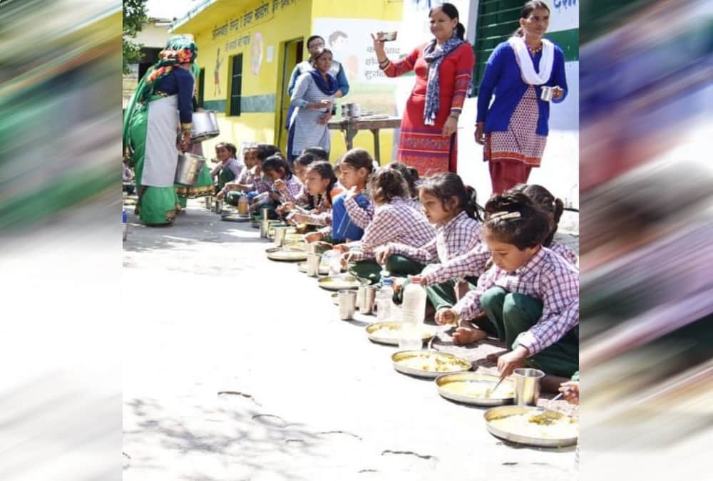 DM Chamoli Swati S Bhadauriya sit on floor and Ate mid day meal with Anganwadi students 