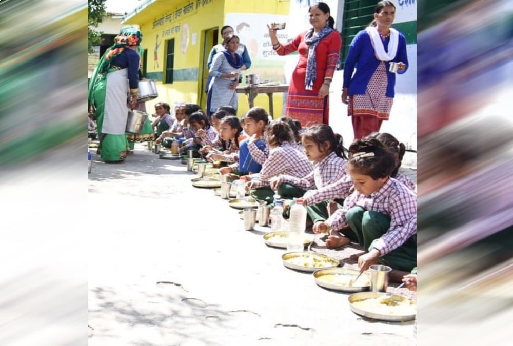 DM Chamoli Swati S Bhadauriya sit on floor and Ate mid day meal with Anganwadi students 