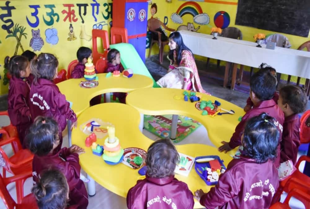 DM Chamoli Swati S Bhadauriya sit on floor and Ate mid day meal with Anganwadi students 