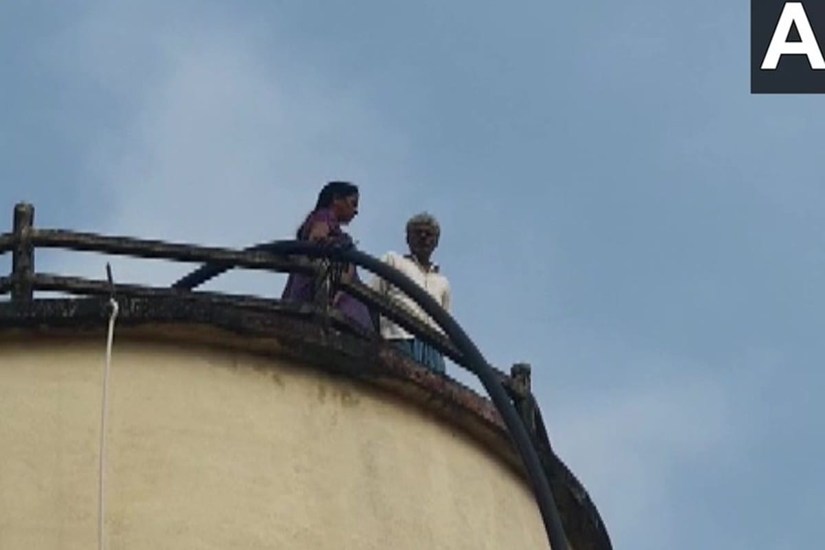 elderly couple climbed atop a water tank alleging that he had given Rs 50 Lakhs to village heads