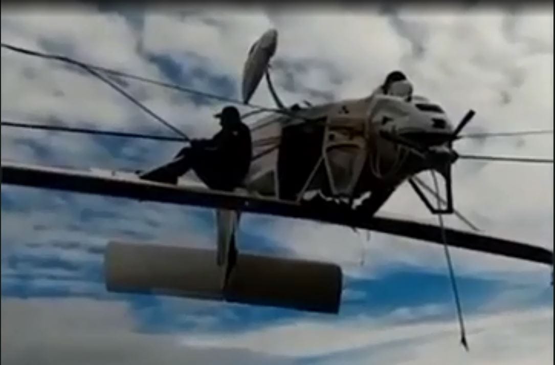 A Small Plane Dangles Upside Down From Ski Lift Cables After Crash In Italian alps