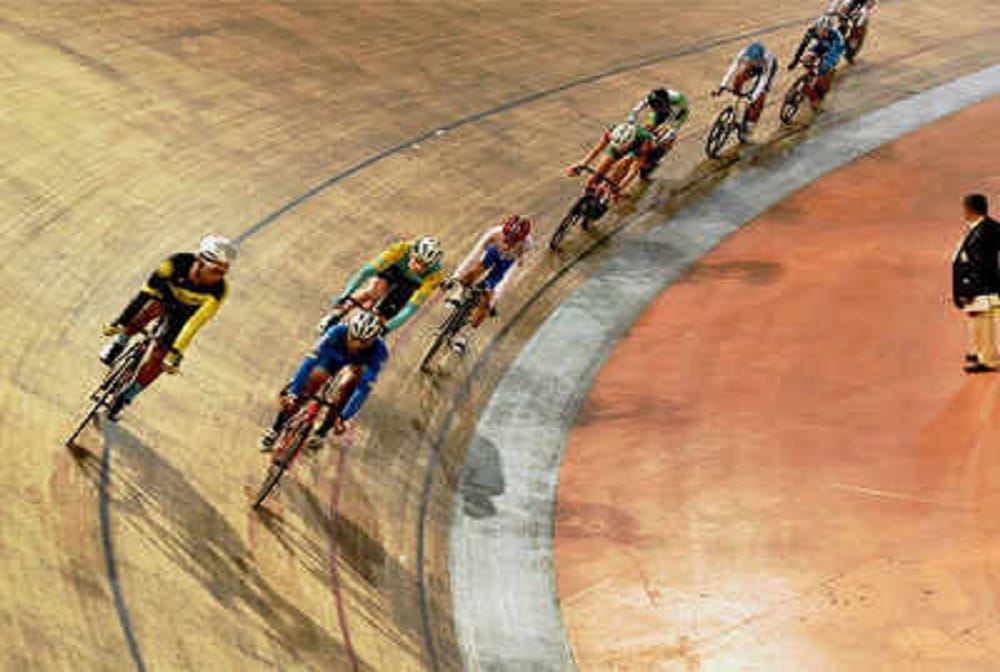 Closed Velodrome, water dripping from stadium roof, Raider away from practice on track,