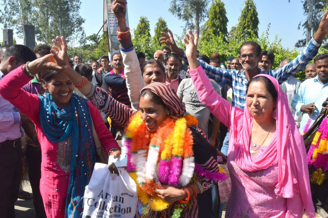 Supporters celebrated Holi outside counting places