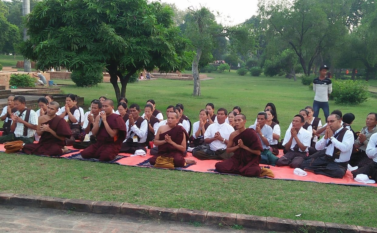 Buddhist followers pray on the gandh kuti