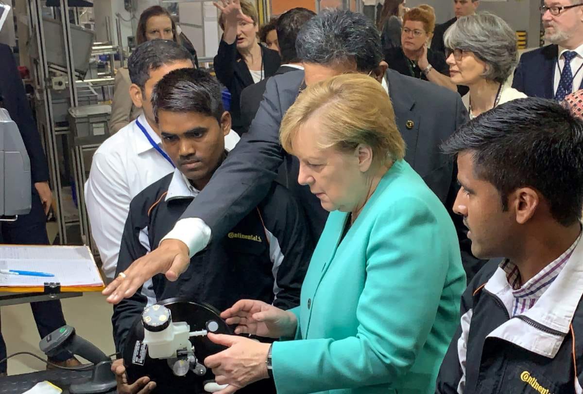 Germany chancellor angela merkel meets e rikshaw operators dwarka delhi invest 1 bn euro in india