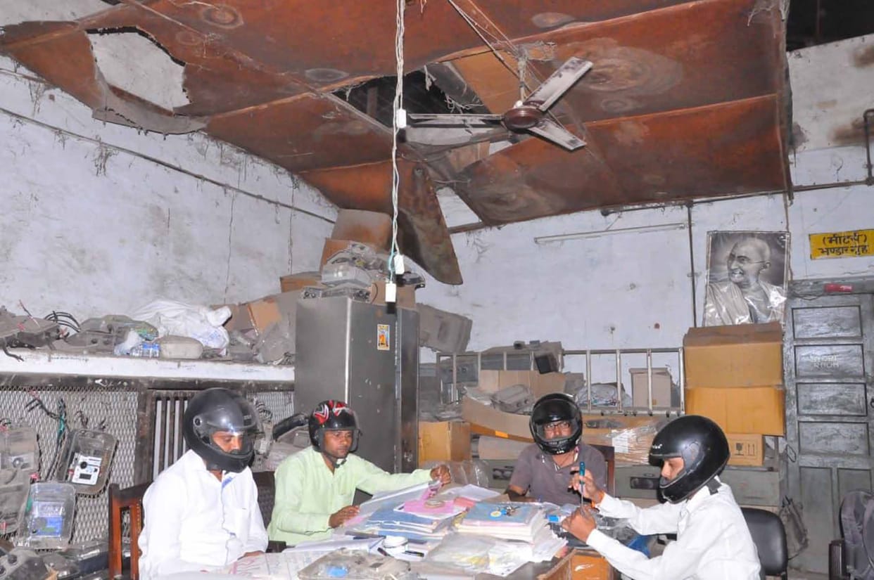 Workers put helmets to replace a shabby ply