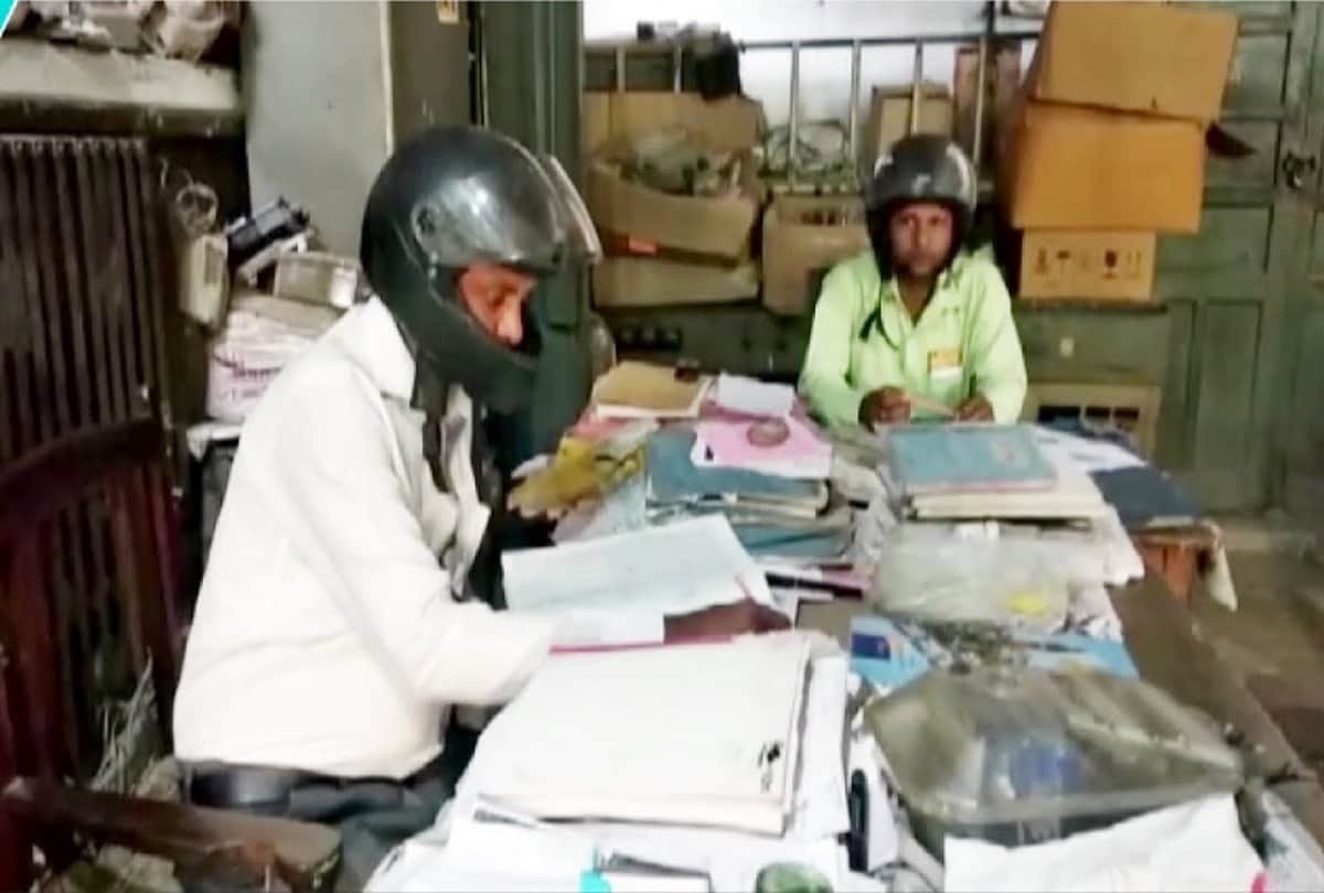 government employees of banda electricity department wear helmets in office to protect themselves