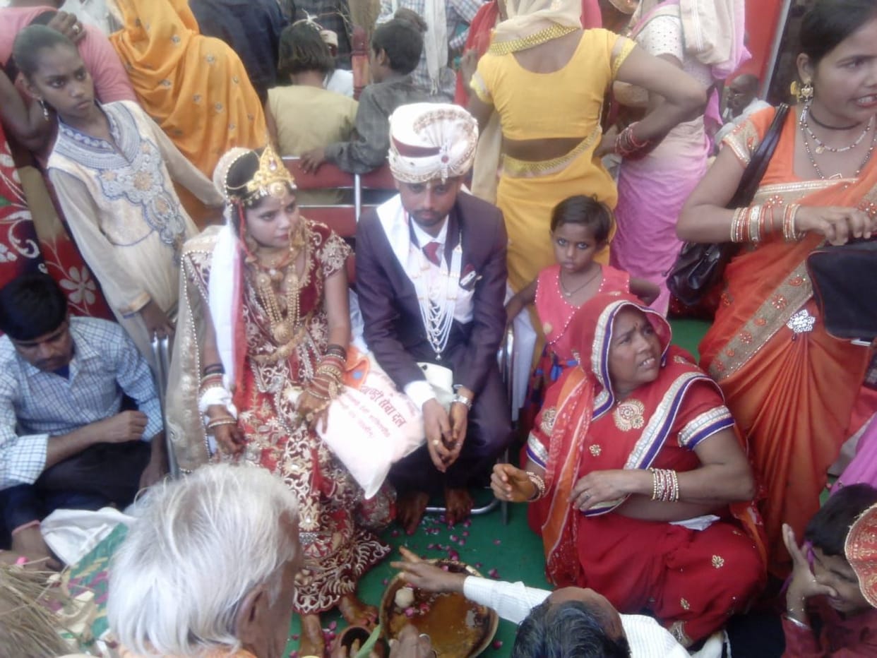 Ten couples hold each other's hand in mass wedding ceremony