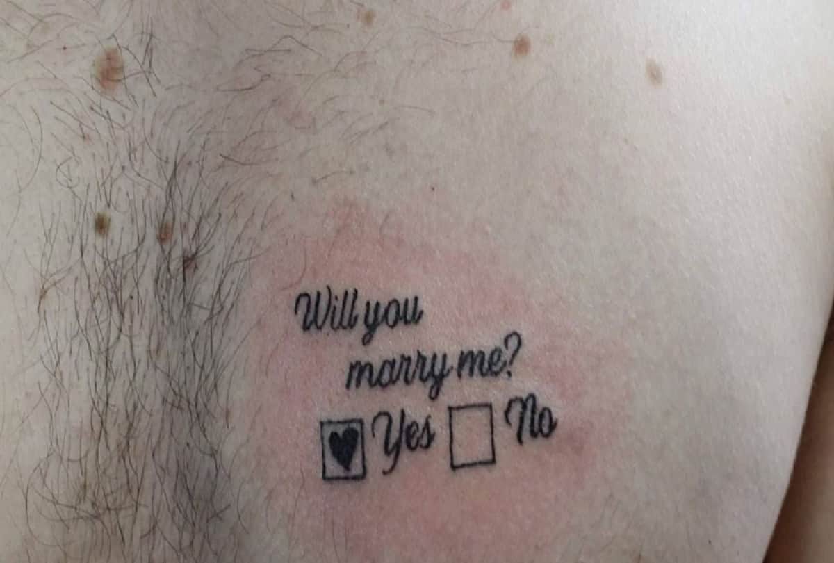 Man proposes his girlfriend in a creative way with Will you marry me tattooed on his chest