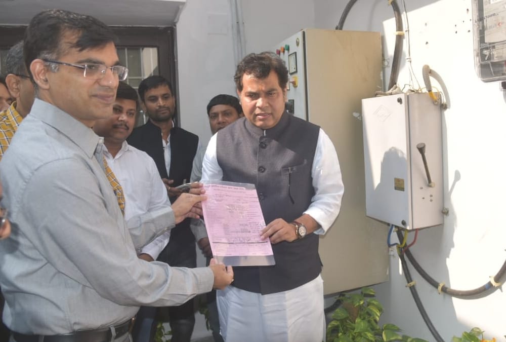 Srikant Sharma puts pre paid electricity meter in his home.