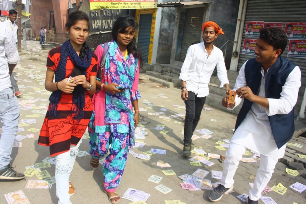 Kashi Vidyapeeth Student Union election candidate seeking votes folded hands in front of student