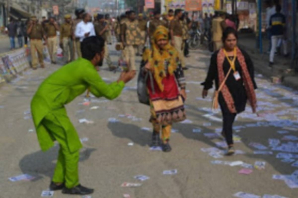Kashi Vidyapeeth Student Union election candidate seeking votes folded hands in front of student