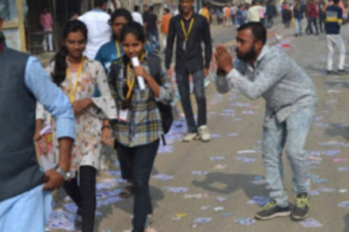 Kashi Vidyapeeth Student Union election candidate seeking votes folded hands in front of student