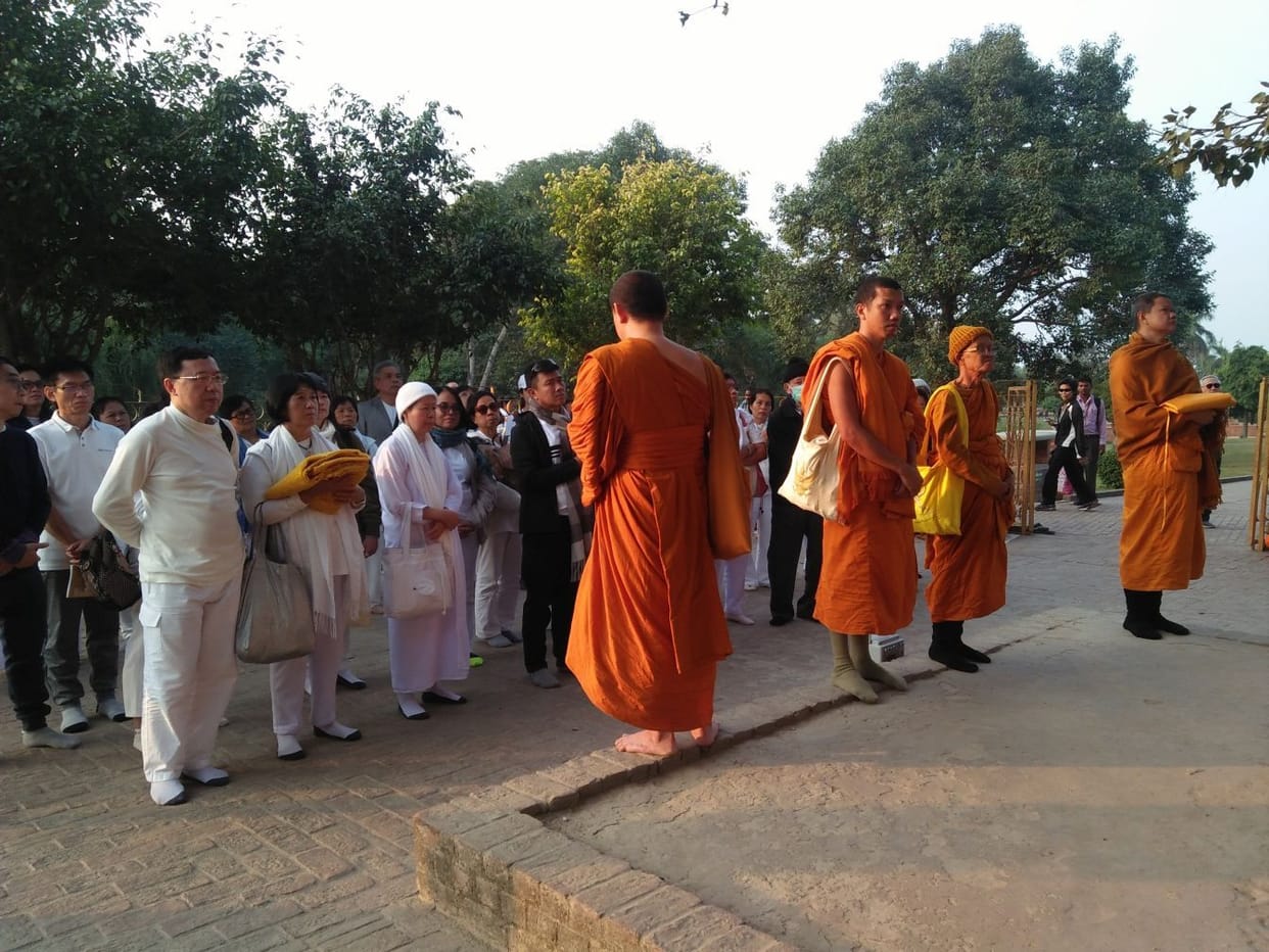 Buddhist followers from Thailand worship at Taposthali