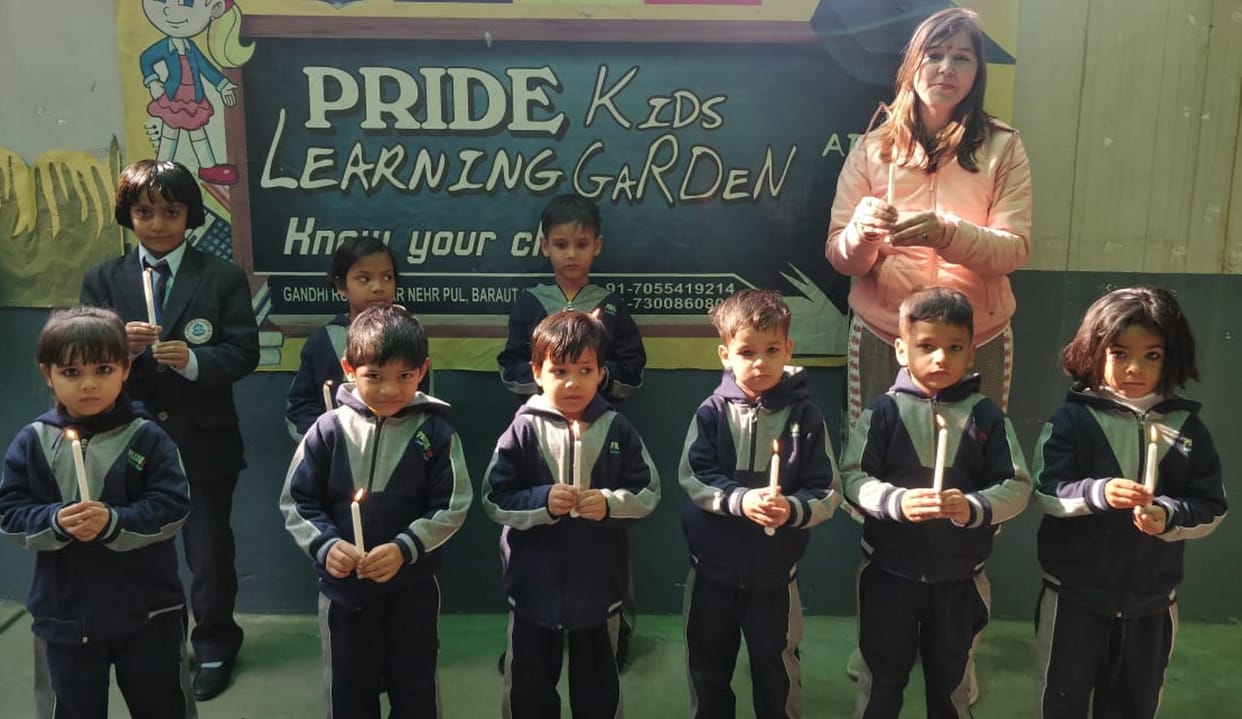 Children pay tribute by burning candles