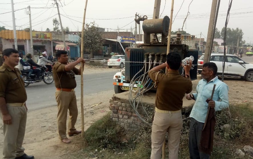 Police put fence of transformer open on the ground