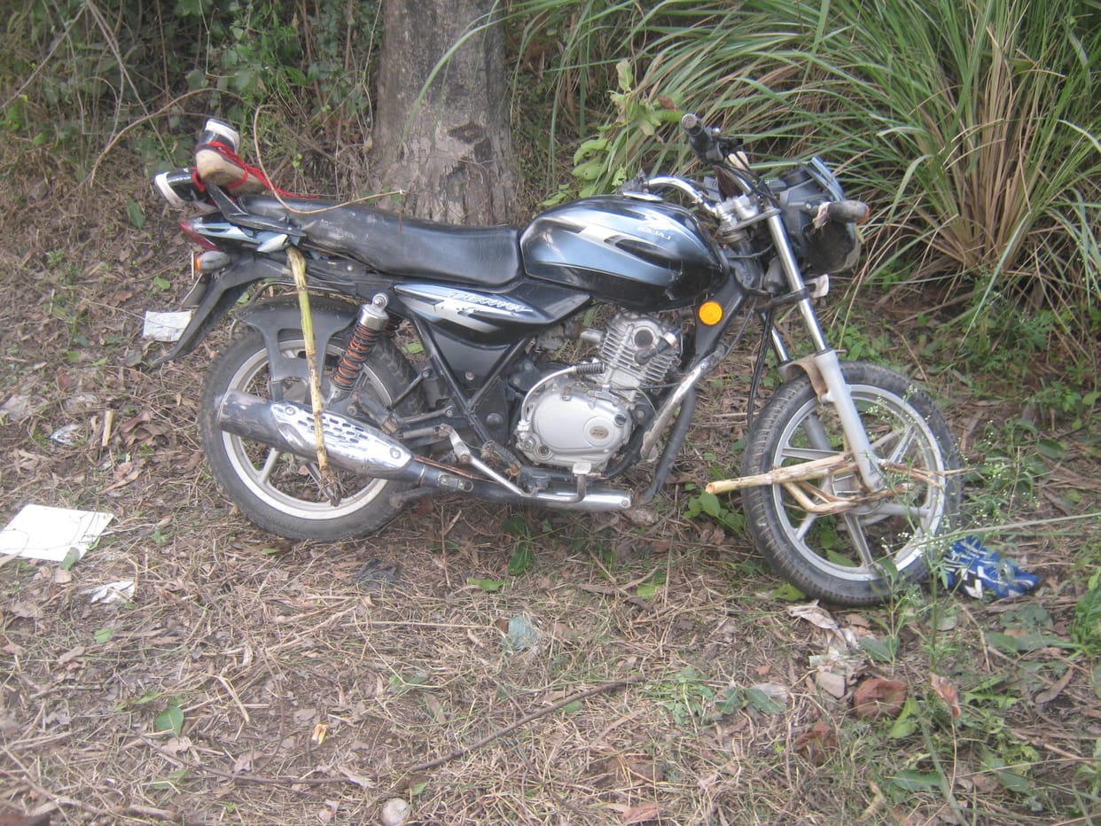 Sugarcane truck overturns, couple riding bike buried down