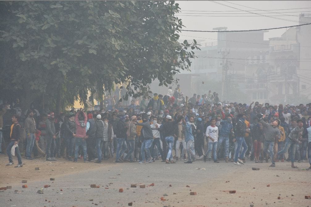 CAA Protest in Aligarh angry mob threw stones on policemen hosts black flags