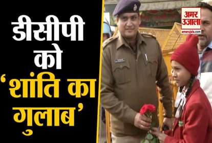 in between CAA Protest school girl give rose to DCP