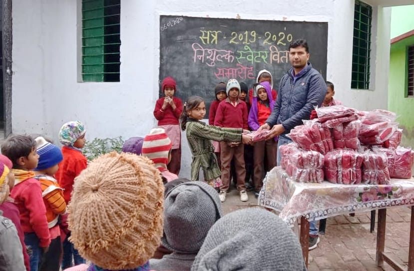 Distribute sweaters to children