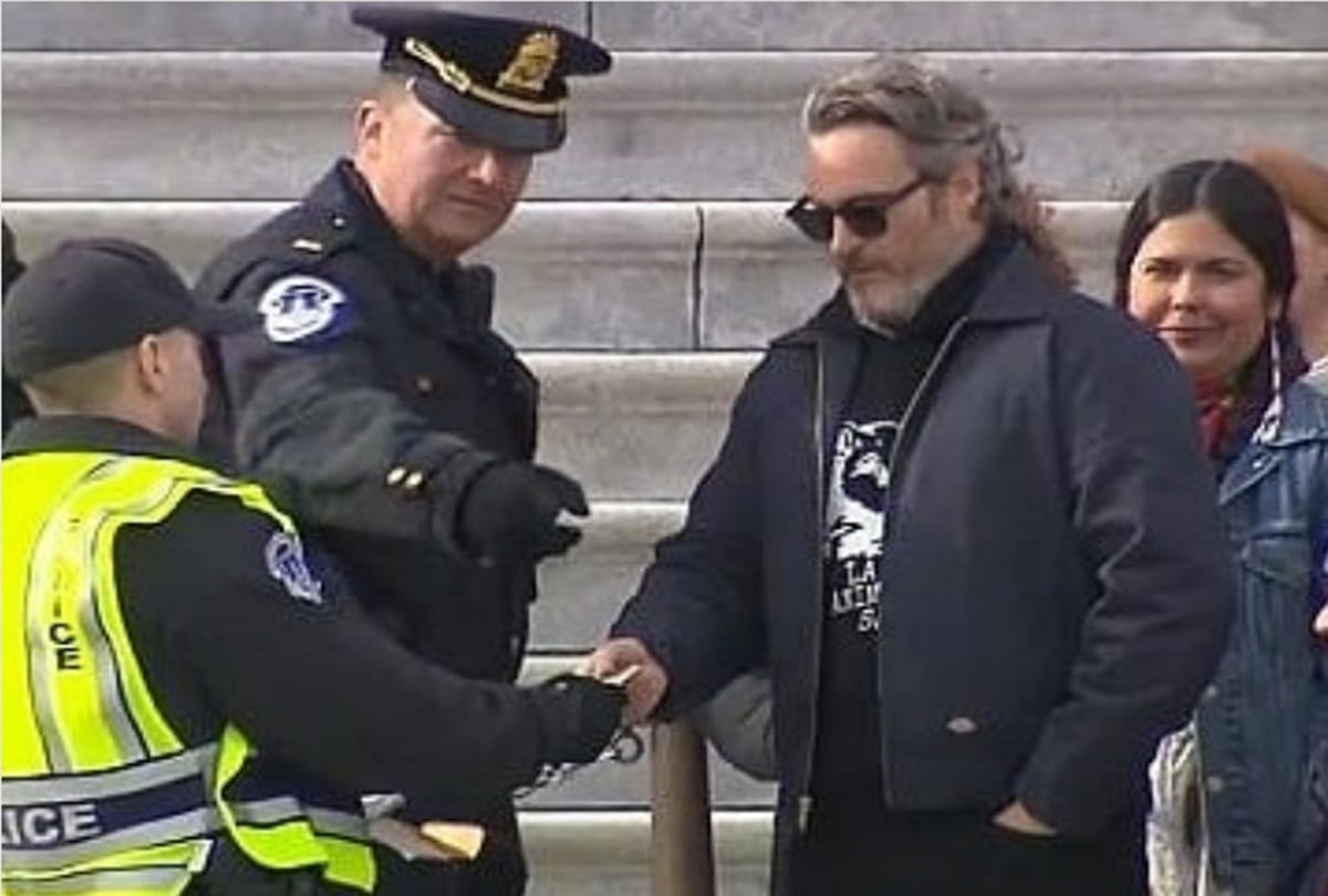 Joker Joaquin Phoenix has been lead away by the police today at Jane's Fonda protest