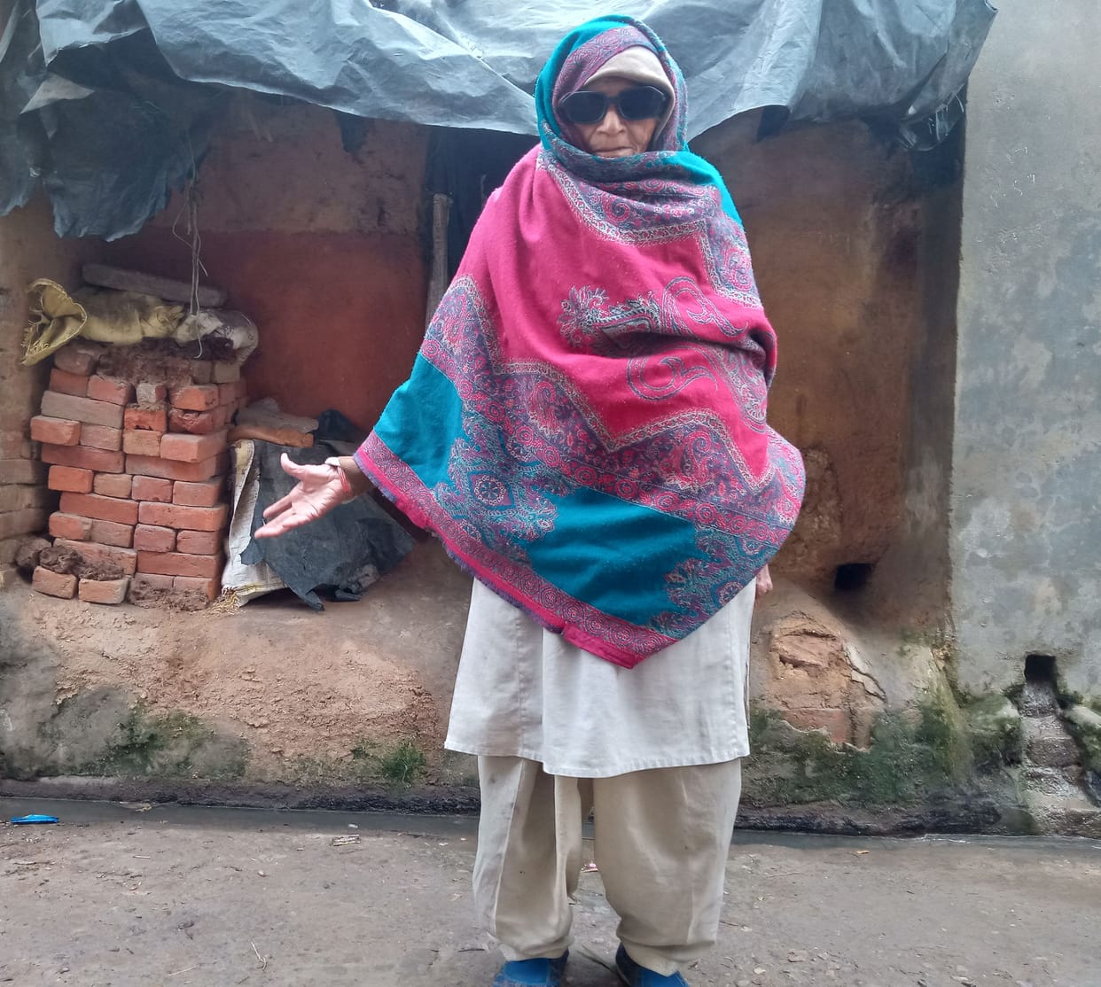 Elderly woman living in a kutcha house