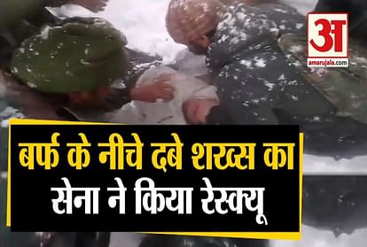 Indian Army personnel rescue a civilian Tariq Iqbal who was caught in a snow slide in Lacchipura