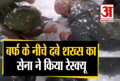 Indian Army personnel rescue a civilian Tariq Iqbal who was caught in a snow slide in Lacchipura