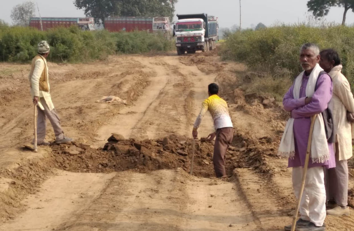 Farmers raging on the way of sand trucks made in the field