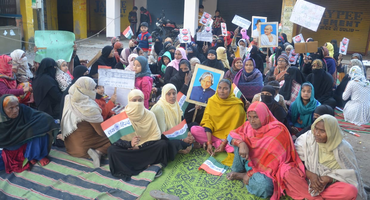 Demonstration of women with posters of Mahatma Gandhi-Bhagat Singh in their hands