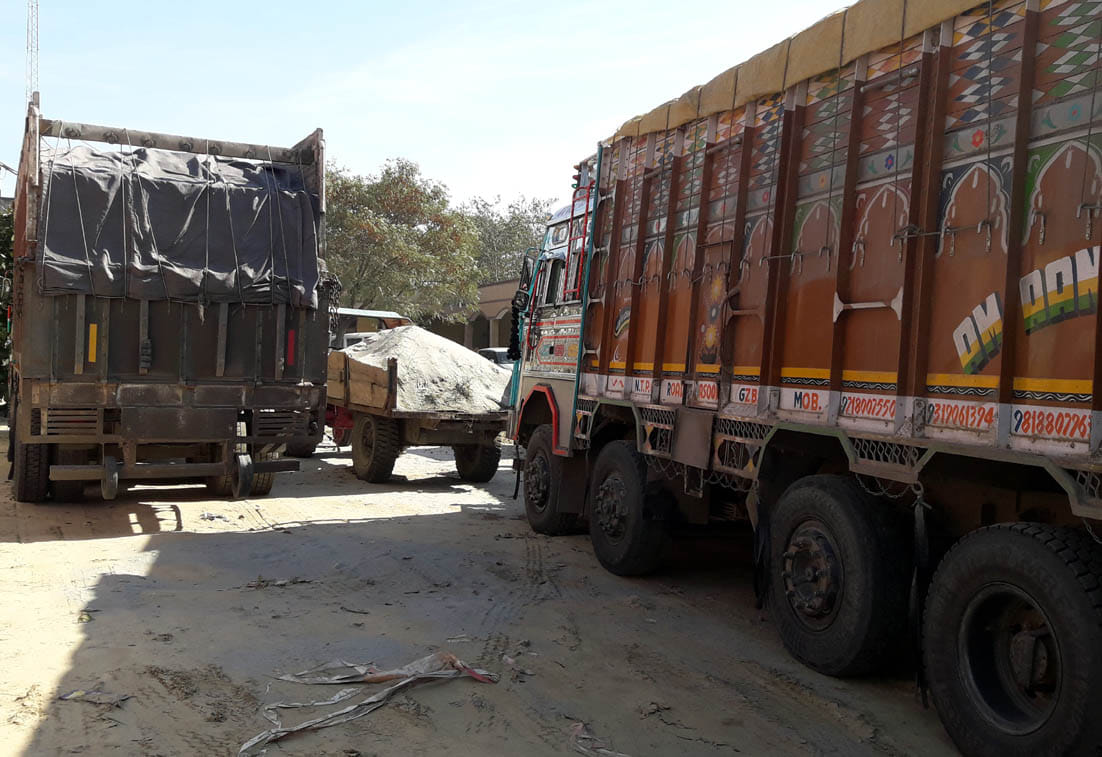 Two overload trucks laden with roadies