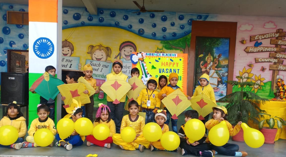 Children fly kites at the Ambience Academy in spring