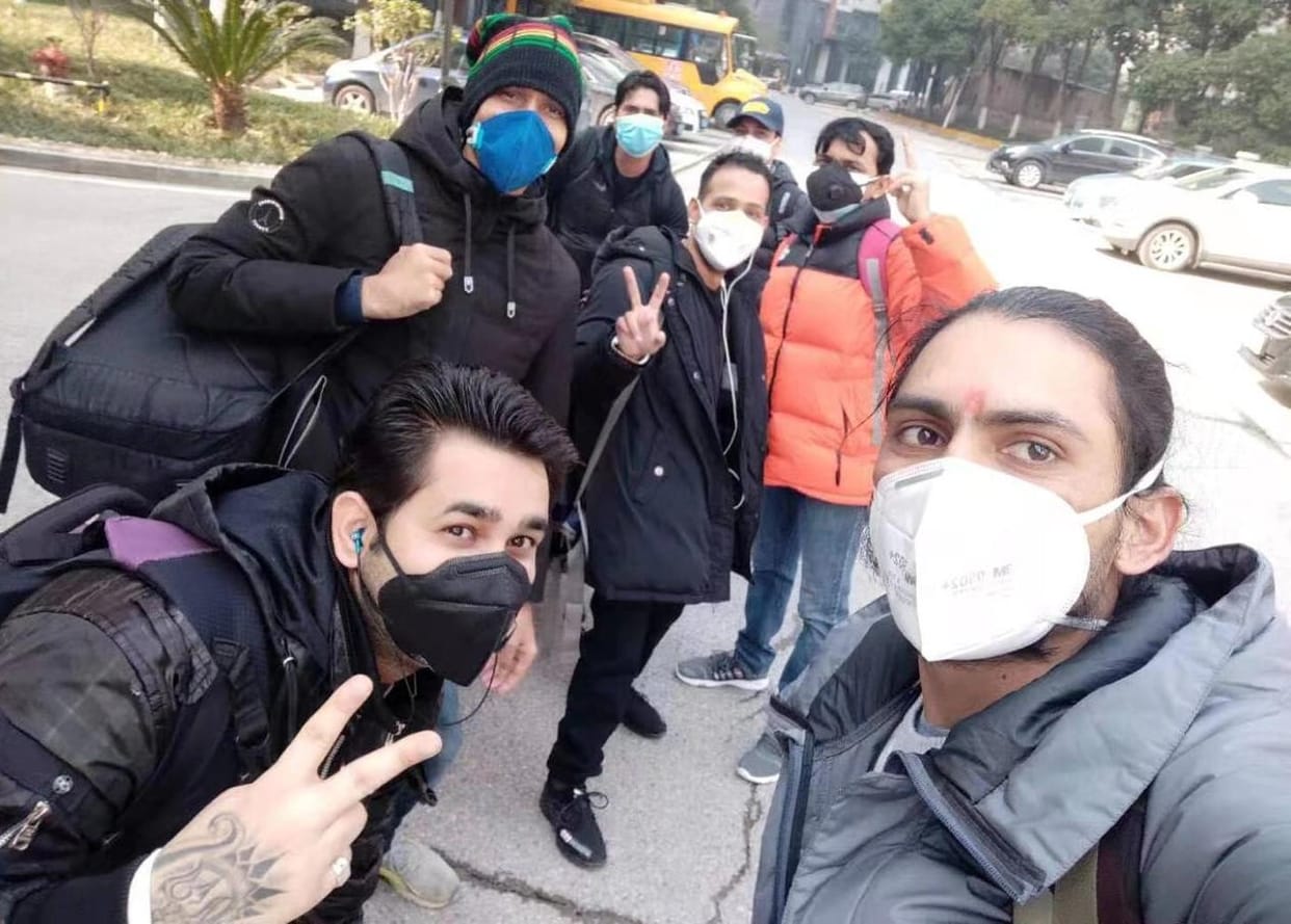 Preparing to return home from China, family members eagerly wait